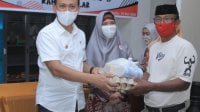 Bapati Talalar saat menyerahkan bantuan kepada warga terdampak Covid 19. (Ist)